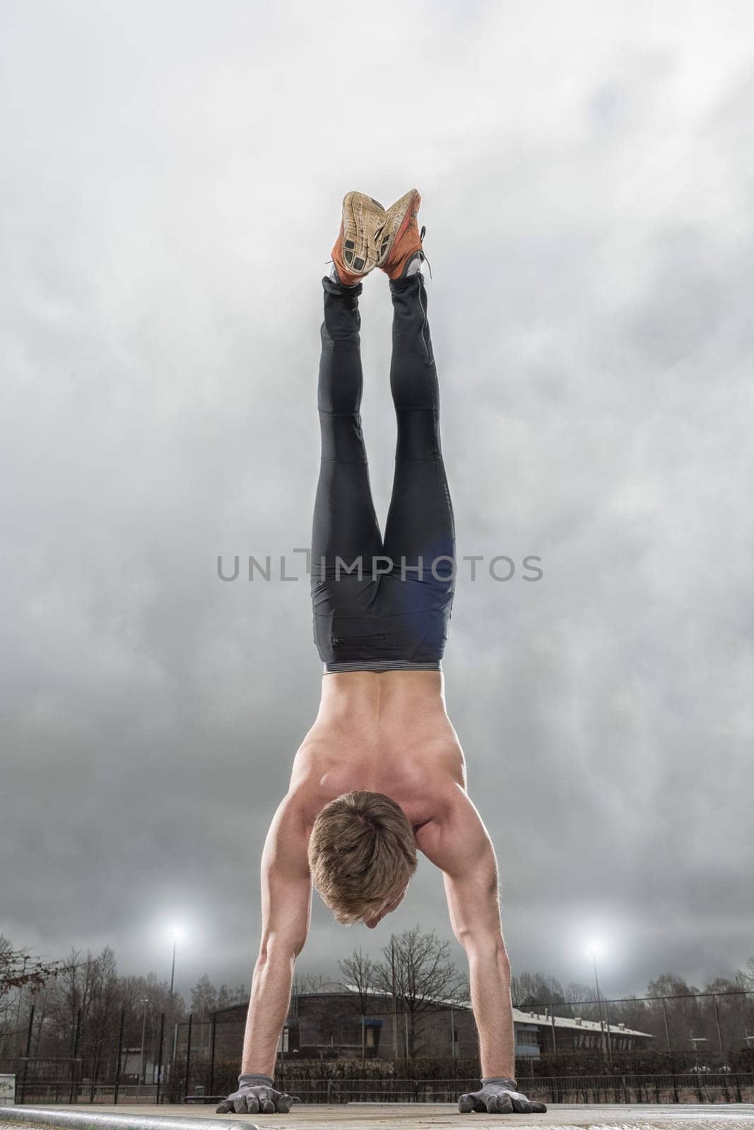 Young man makes a handstand