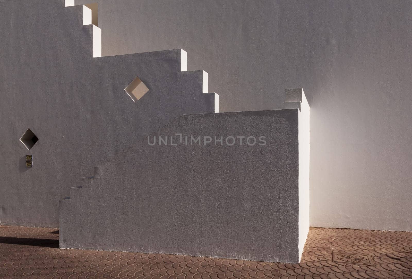 The small part of the white facade of the building in Egypt. side view