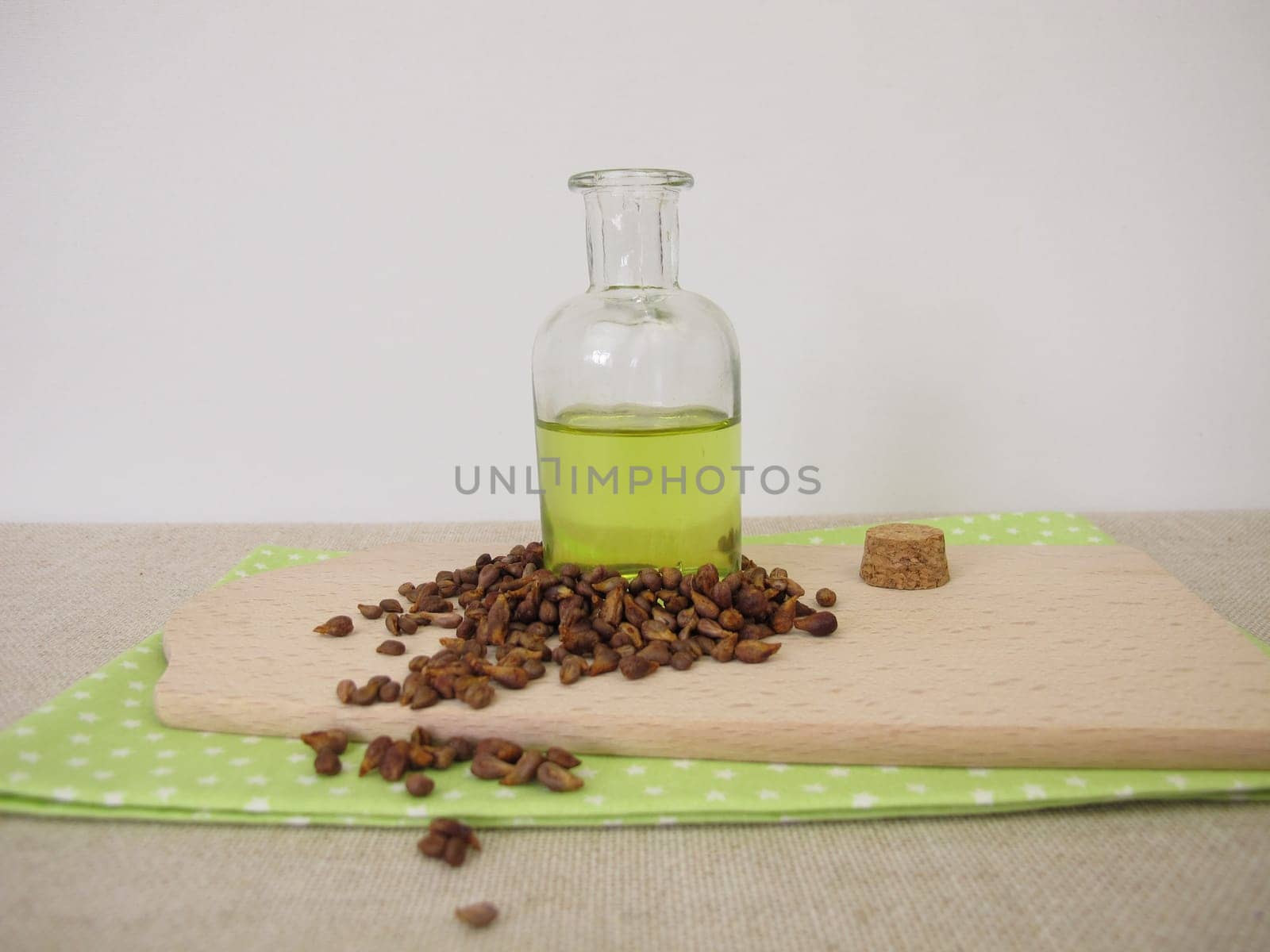 Healthy grape seed oil from grapeseeds in a glass bottle