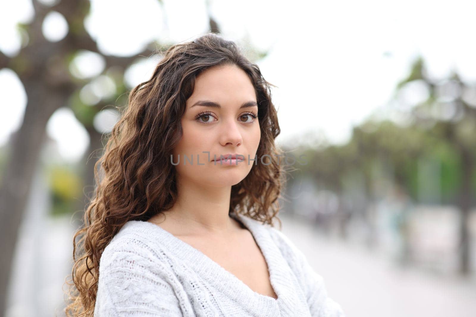 Serious woman looking at camera in the street