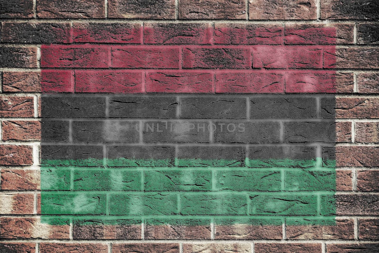 An African American flag on a brick wall background