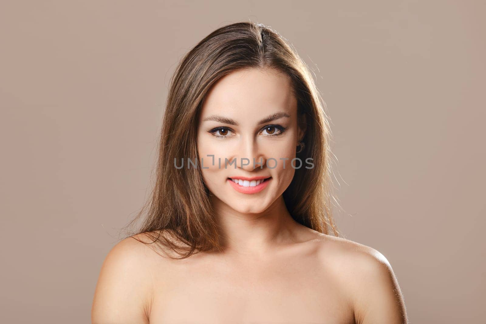 Smiling young woman with perfect face skin and natural makeup