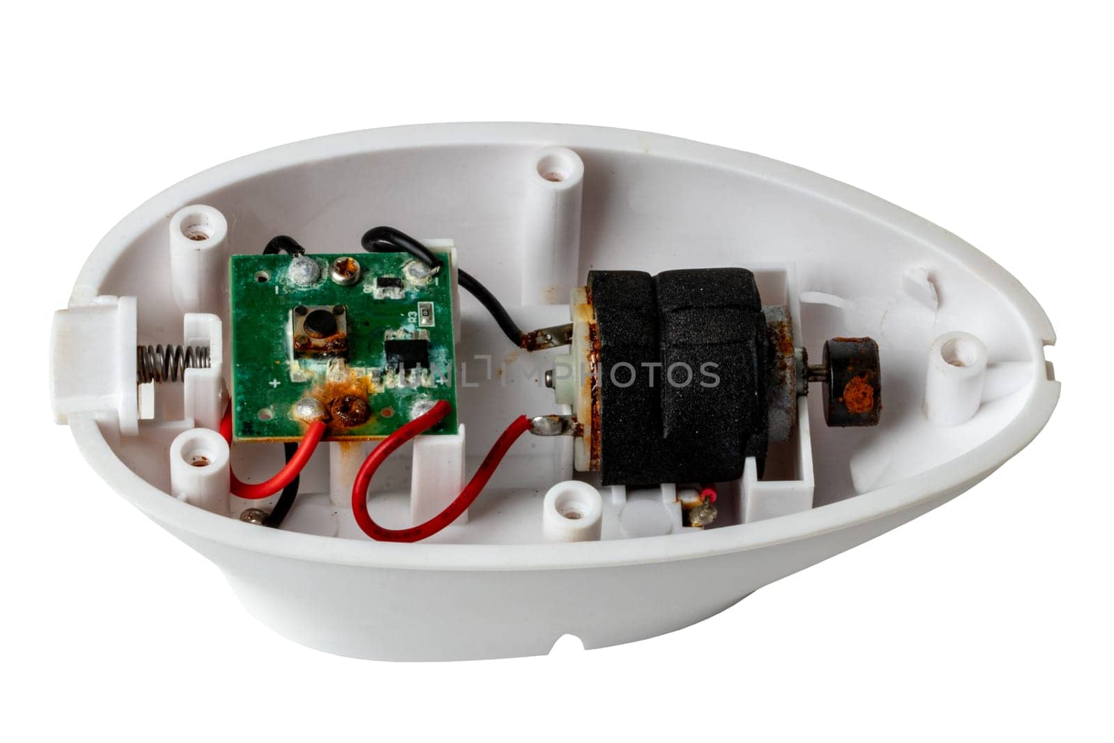 An opened scalp massage brush for exfoliating and massaging the scalp which has rusted due to moisture penetration inside and has thus been destroyed.