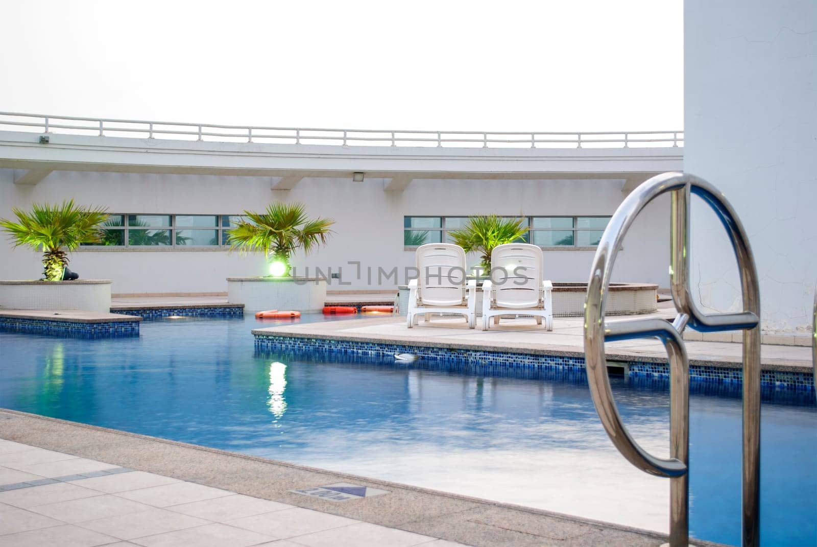 Swimming pool on the top of the roof in modern residential building in Dubai.