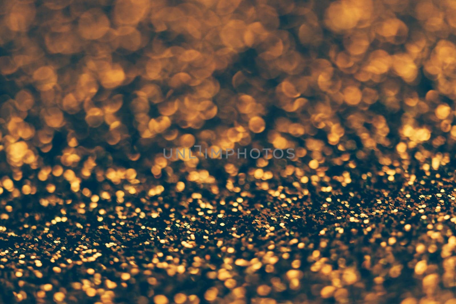 Blur neon gold light circle background. Sparkling firework bokeh dots in retro film filter style. Luxury and classy new year and christmas celebration party textured backdrop. Blurry golden dust particles.