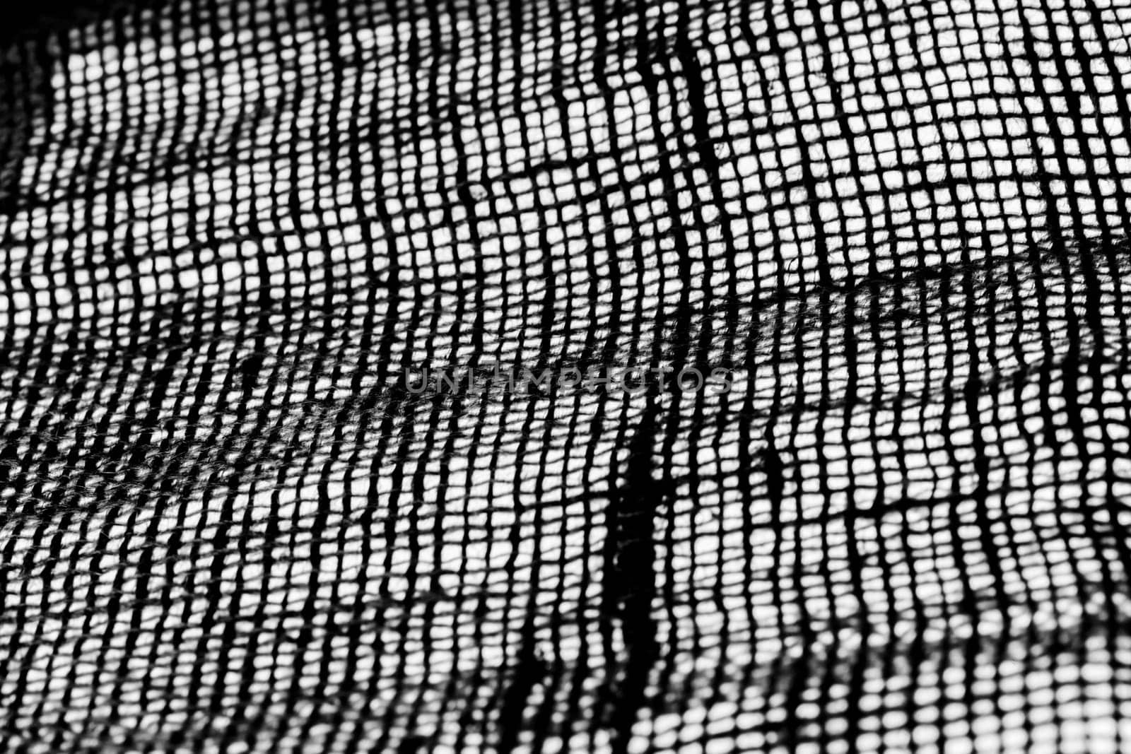Studio shot close-up of frame-filling coarse burlap in black and white implementation.