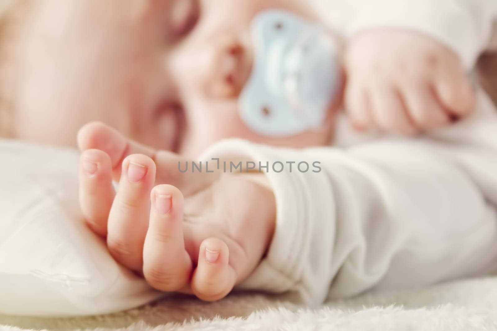Cute five month old baby sleeping in comfortable bed. Concept of the family andparenting.