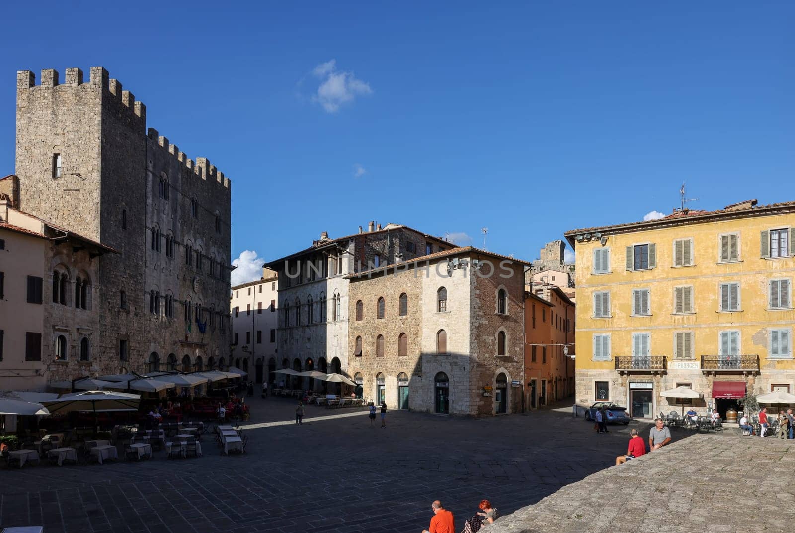Massa Marittima, Italy - Sept 11, 2022: Garibaldi square and Palazzo del Podesta in Massa Marittima. Italy
