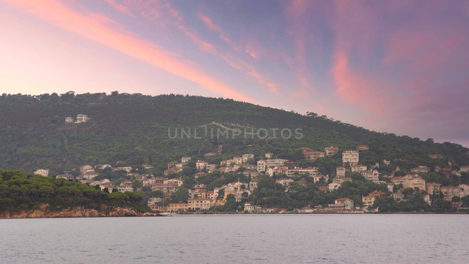 View of the mountains of Kinaliada island from Marmara Sea, with traditional summer houses and boats, Istanbul, Turkey