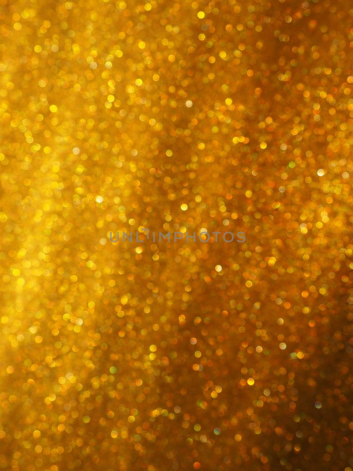 Bokeh light of gold glitters. Golden glitter texture background. Sparkling glitter wrapping paper with sequins and sparkles. Festive golden bokeh and glitter. Diagonal stripes and waves.