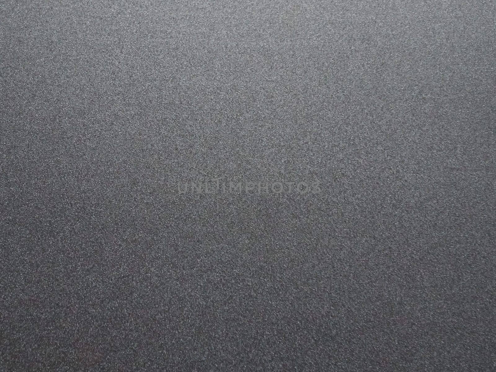 Black glitter texture christmas background. Bent shiny velvet paper.
