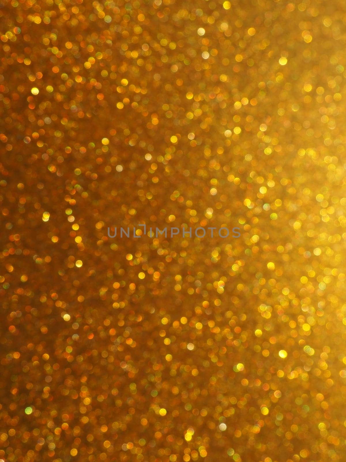 Bokeh light of gold glitters. Golden glitter texture background. Sparkling glitter wrapping paper with sequins and sparkles. Festive golden bokeh and glitter. Beautiful background