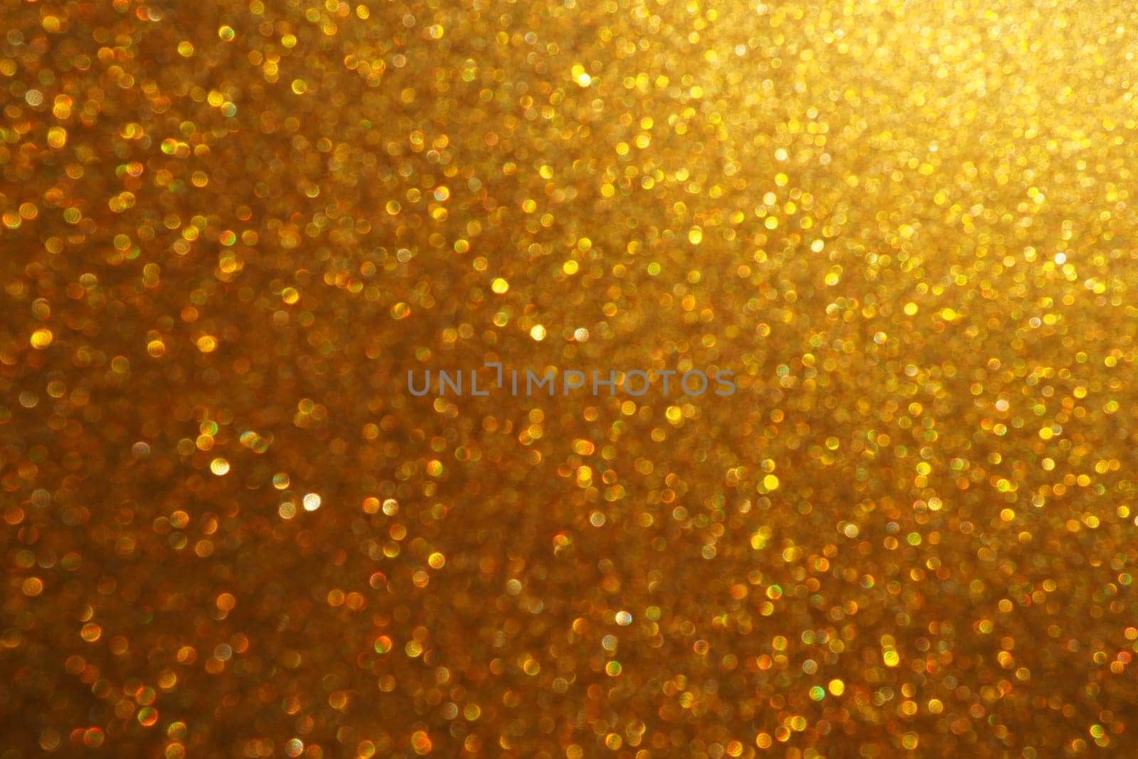 Bokeh light of gold glitters. Golden glitter texture background. Sparkling glitter wrapping paper with sequins and sparkles. Festive golden bokeh and glitter. Beautiful background