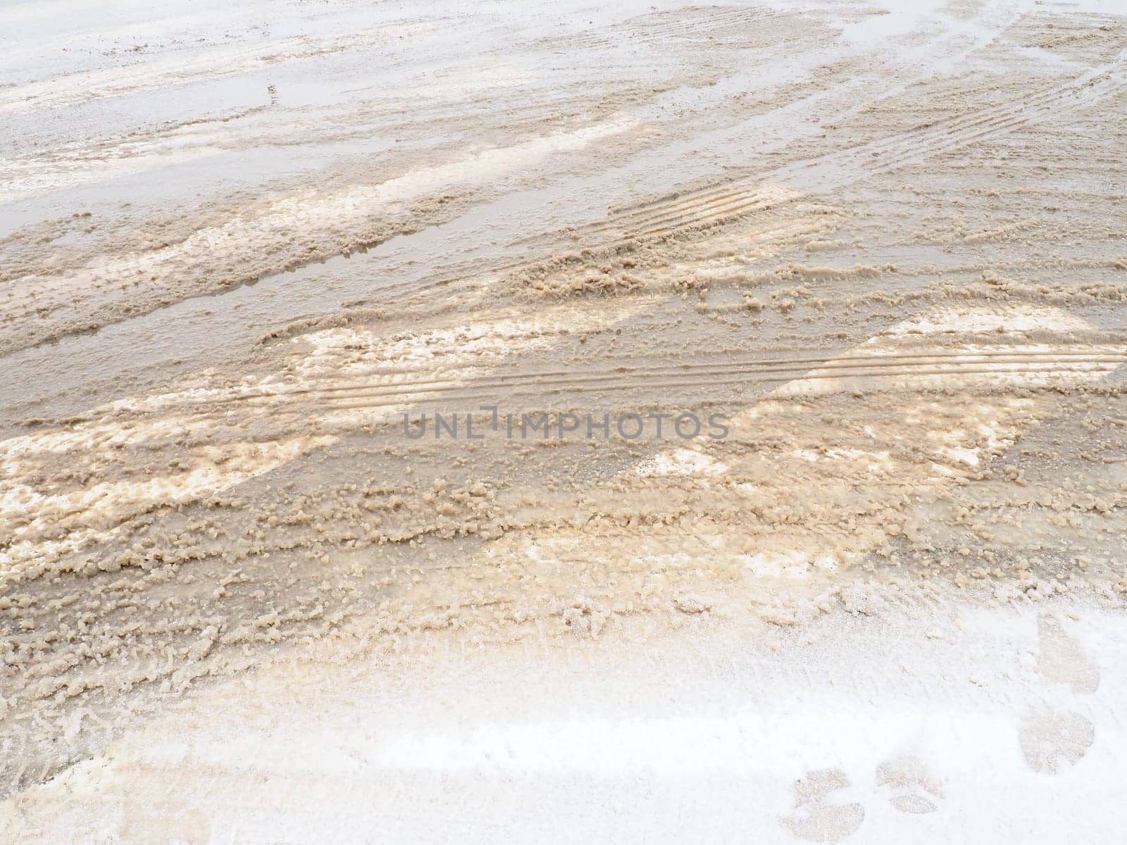 Snow, ice, slush and winter mud at a pedestrian crossing. The air temperature is about 0. Difficult driving conditions. Braking distance of the car. Traffic Laws. Infrastructure and road services.