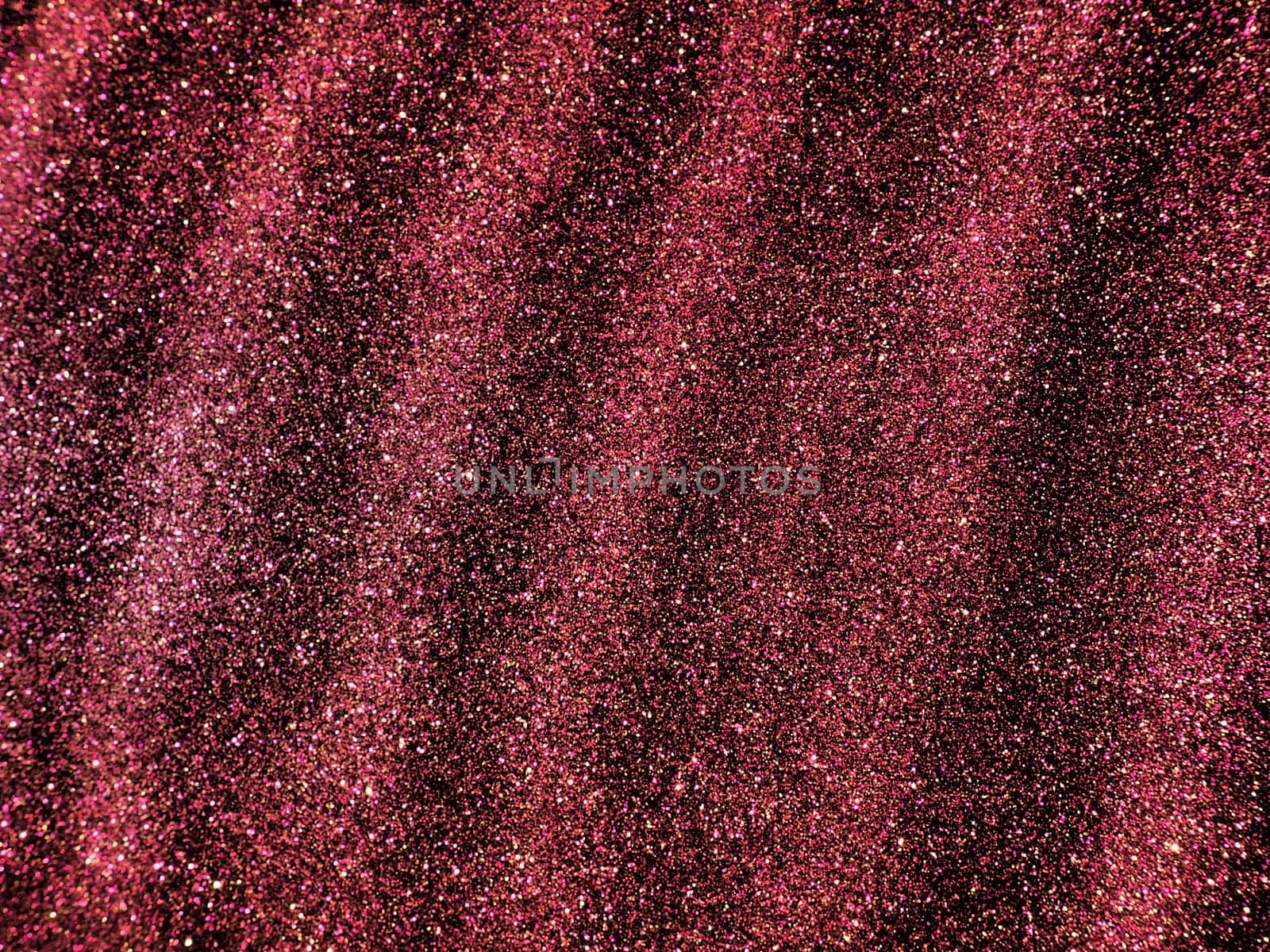 Bokeh light of pink glitters on black background. Magenta glitter texture. Sparkling glitter wrapping paper with sequins and sparkles. Festive purple bokeh and glitter. Diagonal stripes and waves.