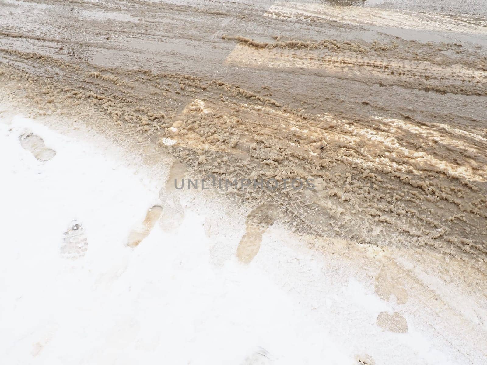 Snow, ice, slush and winter mud at a pedestrian crossing. The air temperature is about 0. Difficult driving conditions. Braking distance of the car. Traffic Laws. Infrastructure and road services.
