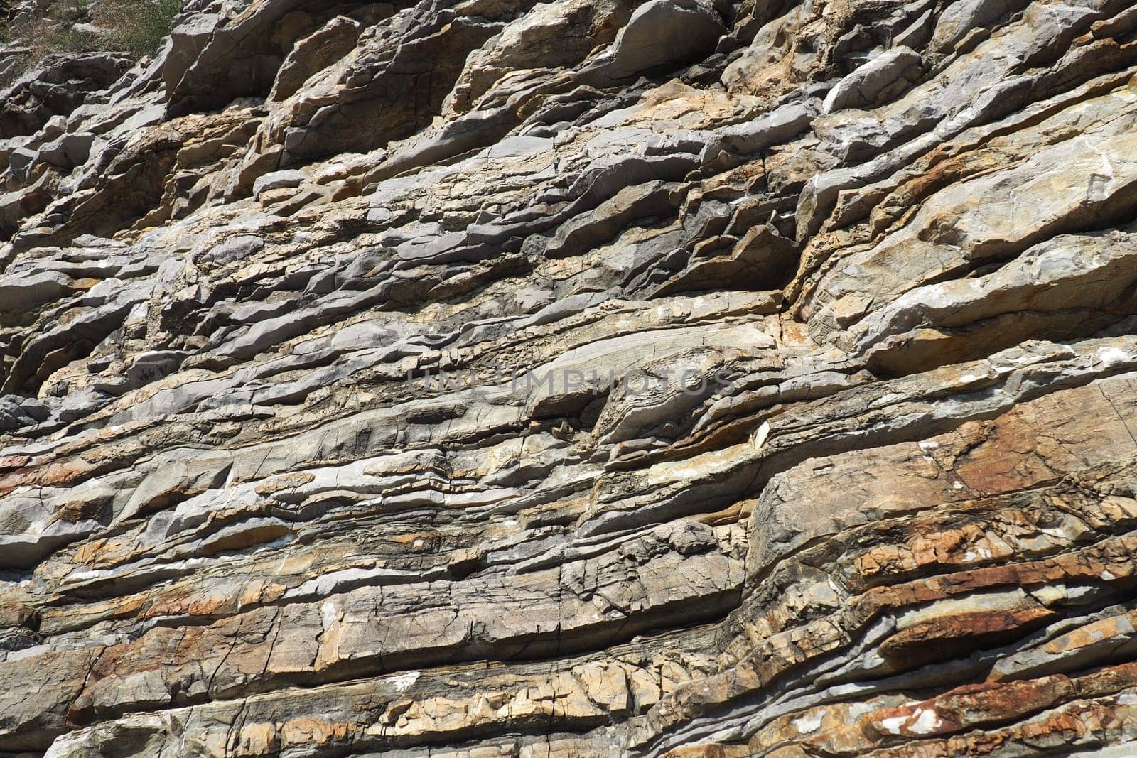 Flysch is a series of marine sedimentary rocks that are predominantly clastic in origin and are characterized by the alternation of lithological layers. Balkans, Montenegro, Budva, Mogren beach.