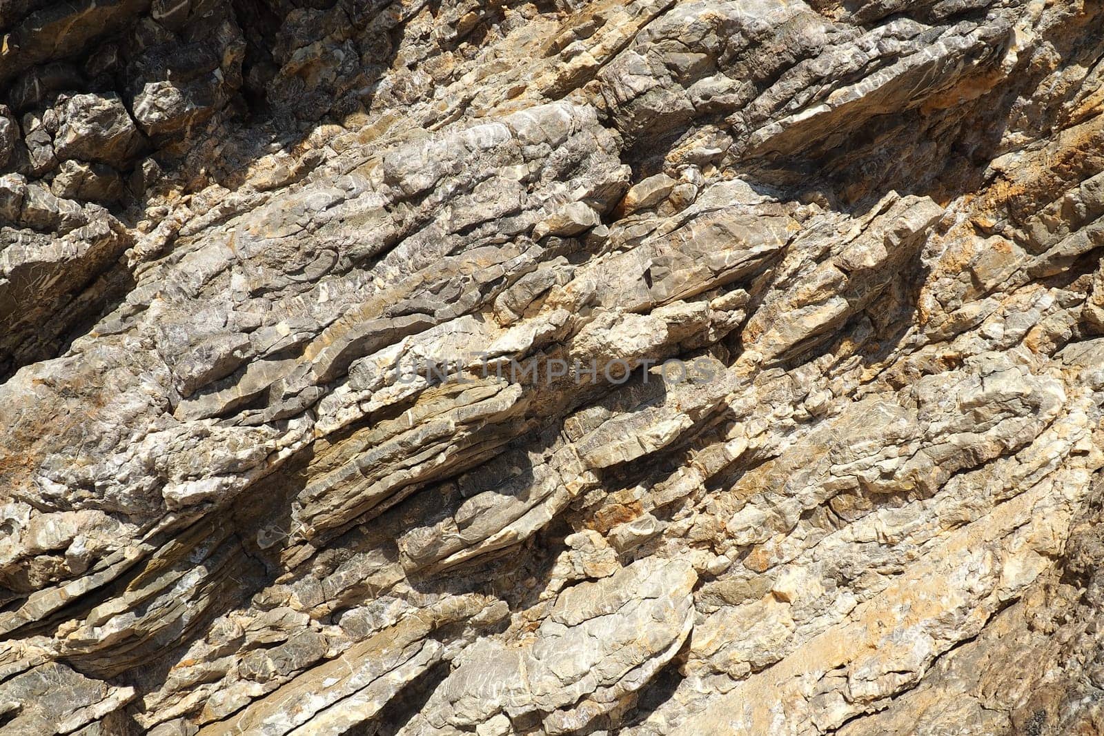Flysch is a series of marine sedimentary rocks that are predominantly clastic in origin and are characterized by the alternation of lithological layers. Balkans, Montenegro, Budva, Mogren beach.