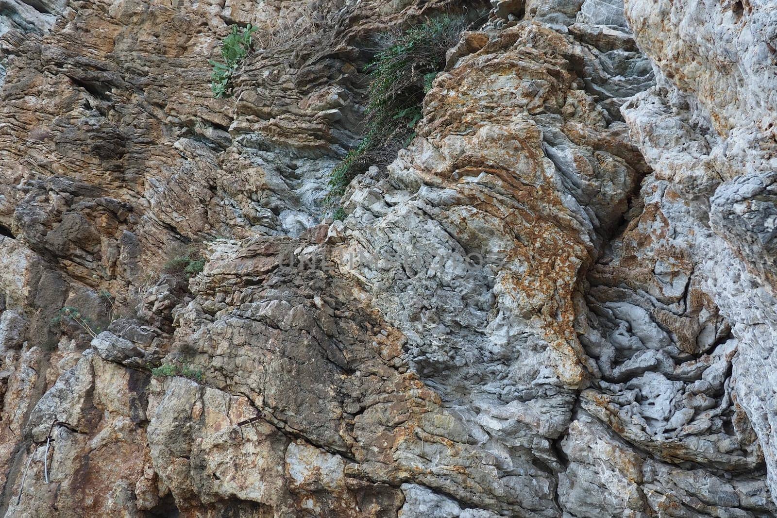 Flysch is a series of marine sedimentary rocks that are predominantly clastic in origin and are characterized by the alternation of lithological layers. Balkans, Montenegro, Budva, Mogren beach.