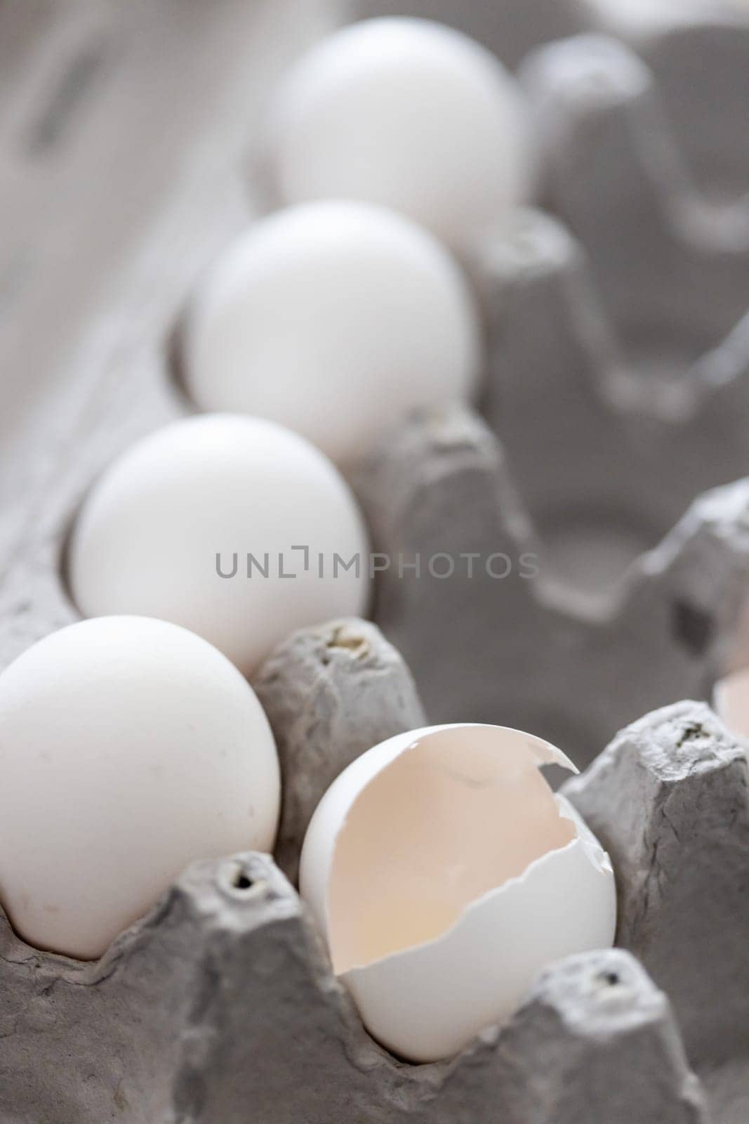 Carton of White Chicken Eggs and Egg Shells.