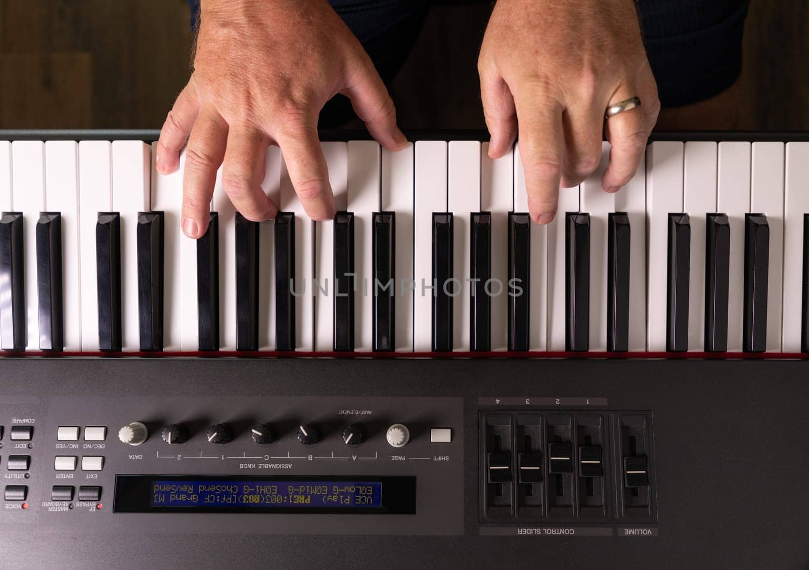 Male Hands Practicing on the Electronic Piano Keyboard.