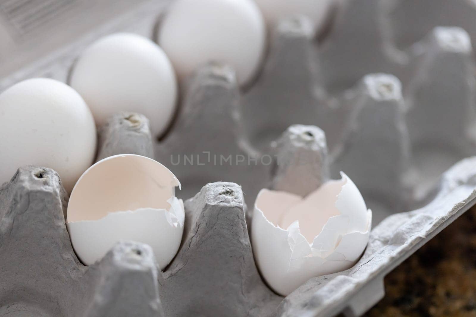 Carton of White Chicken Eggs and Egg Shells.