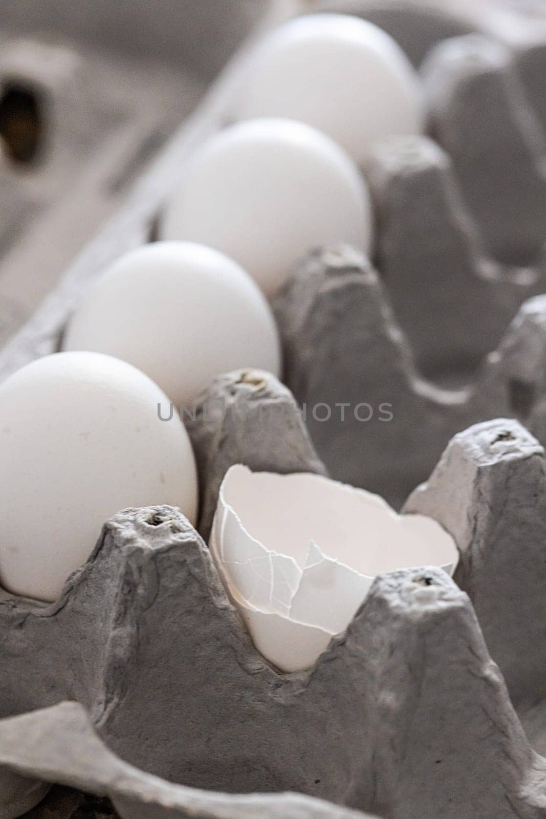 Carton of White Chicken Eggs and Egg Shells.