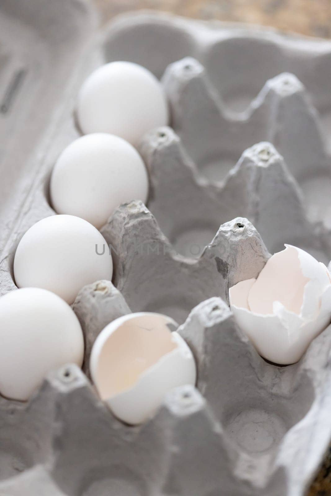 Carton of White Chicken Eggs and Egg Shells.