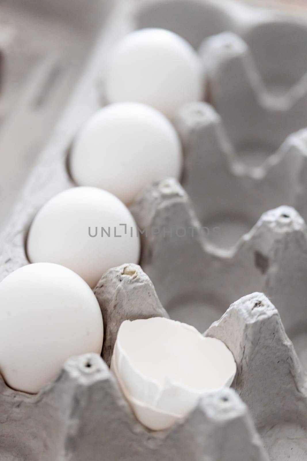 Carton of White Chicken Eggs and Egg Shells.
