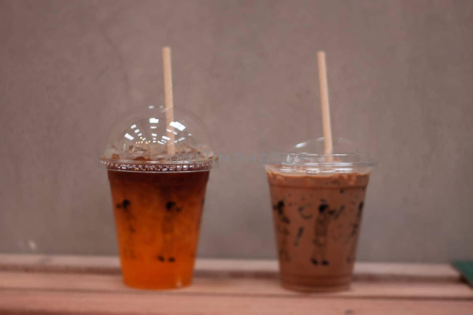 Black coffee with orange juice and iced mocha on wooden table, stock photo