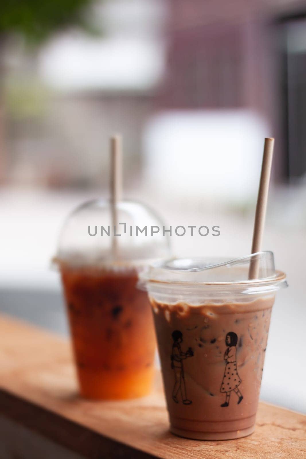 Black coffee with orange juice and iced mocha on wooden table, stock photo