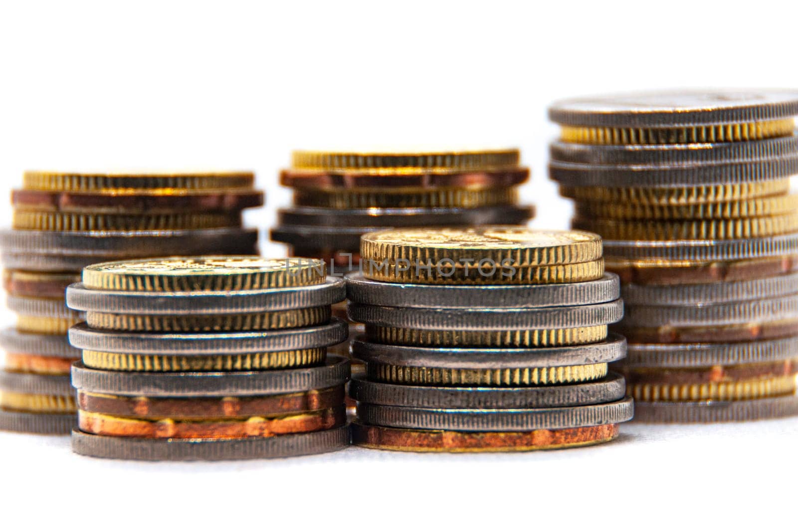 Close up of coins on white background with customizable space for text or ideas. Business and investment concept.