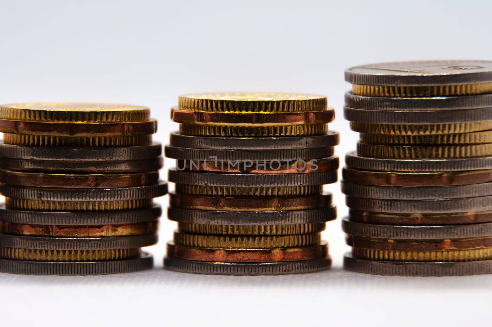 Close up of coins on white background with customizable space for text or ideas. Business and investment concept.