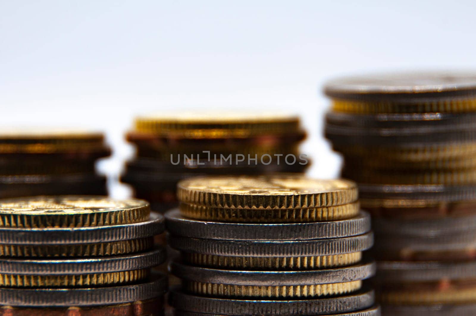 Close up of coins on white background with customizable space for text or ideas. Business and investment concept.