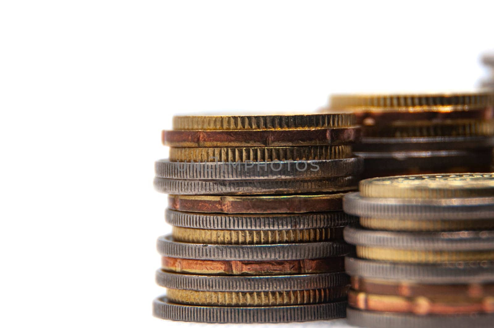 Close up of coins on white background with customizable space for text or ideas. Business and investment concept.