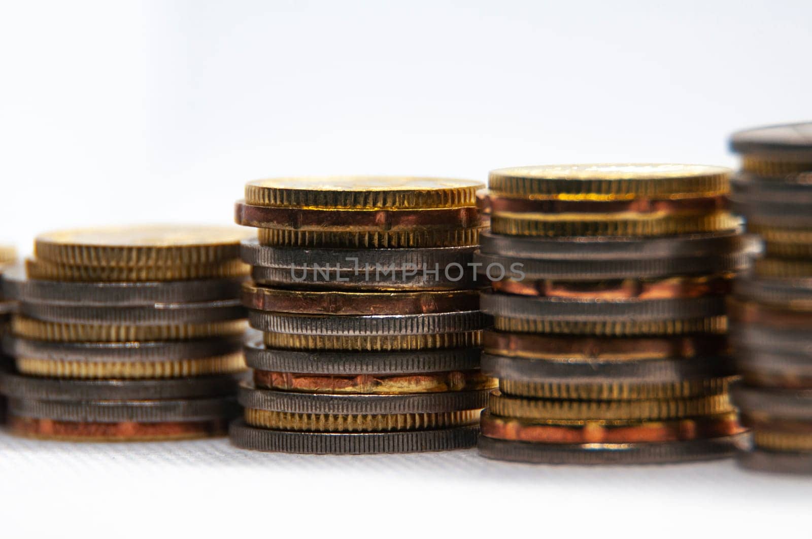 Close up of coins on white background with customizable space for text or ideas. Business and investment concept.