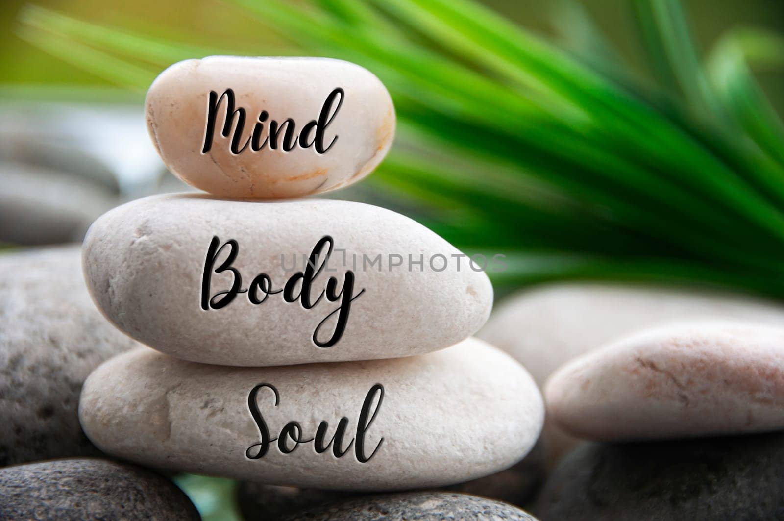 Mind, Body and Soul words engraved on zen stones with space for text. Copy space and zen concept.