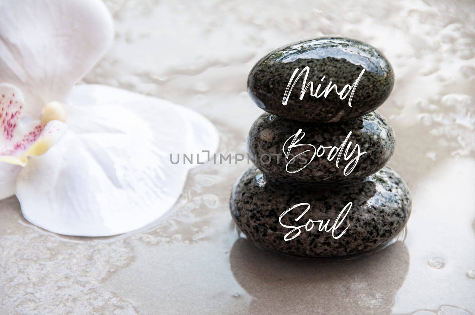 Mind, Body and Soul words engraved on zen stones with space for text. Copy space and zen concept.