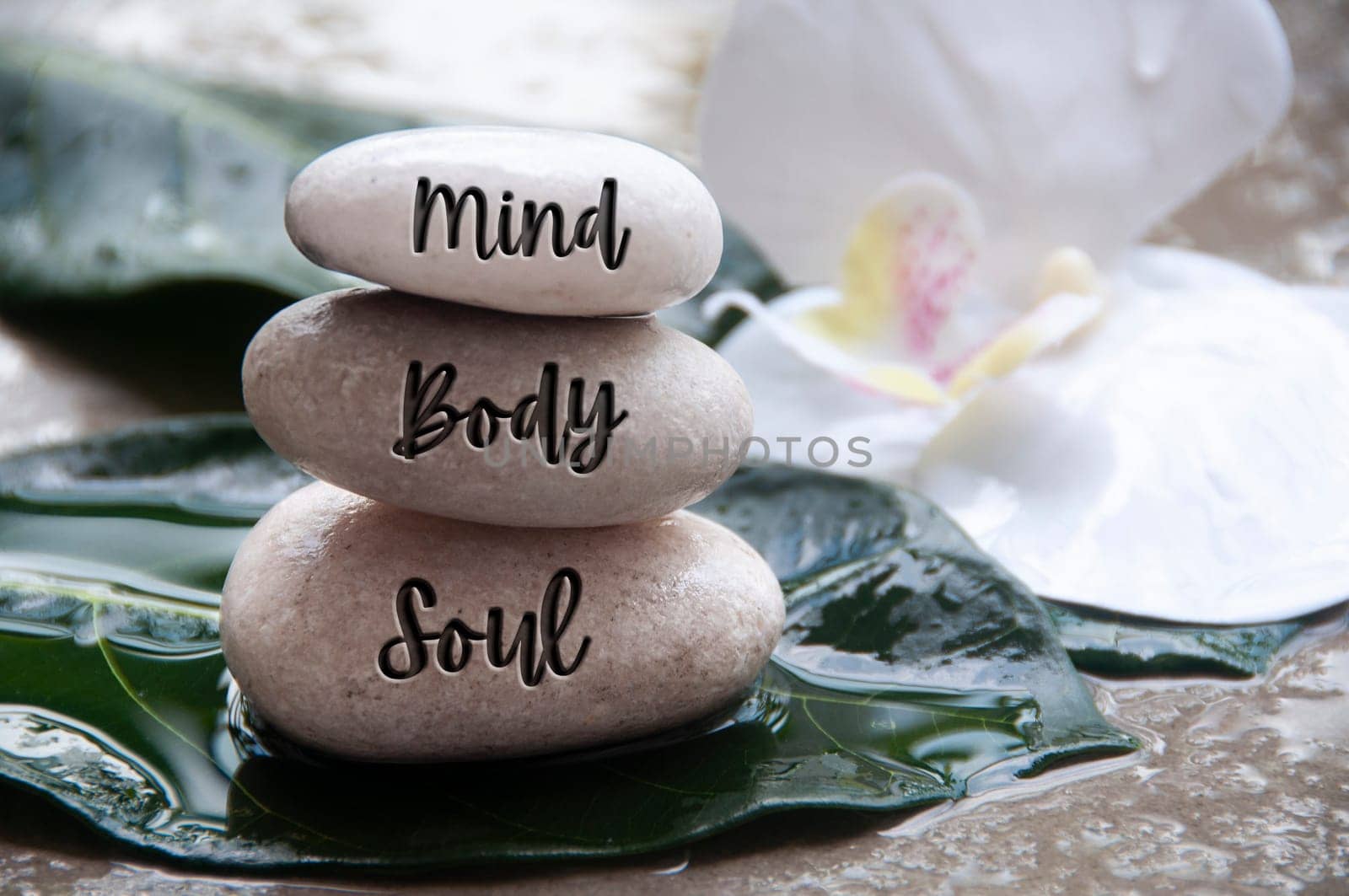 Mind, Body and Soul words engraved on zen stones with space for text. Zen concept.