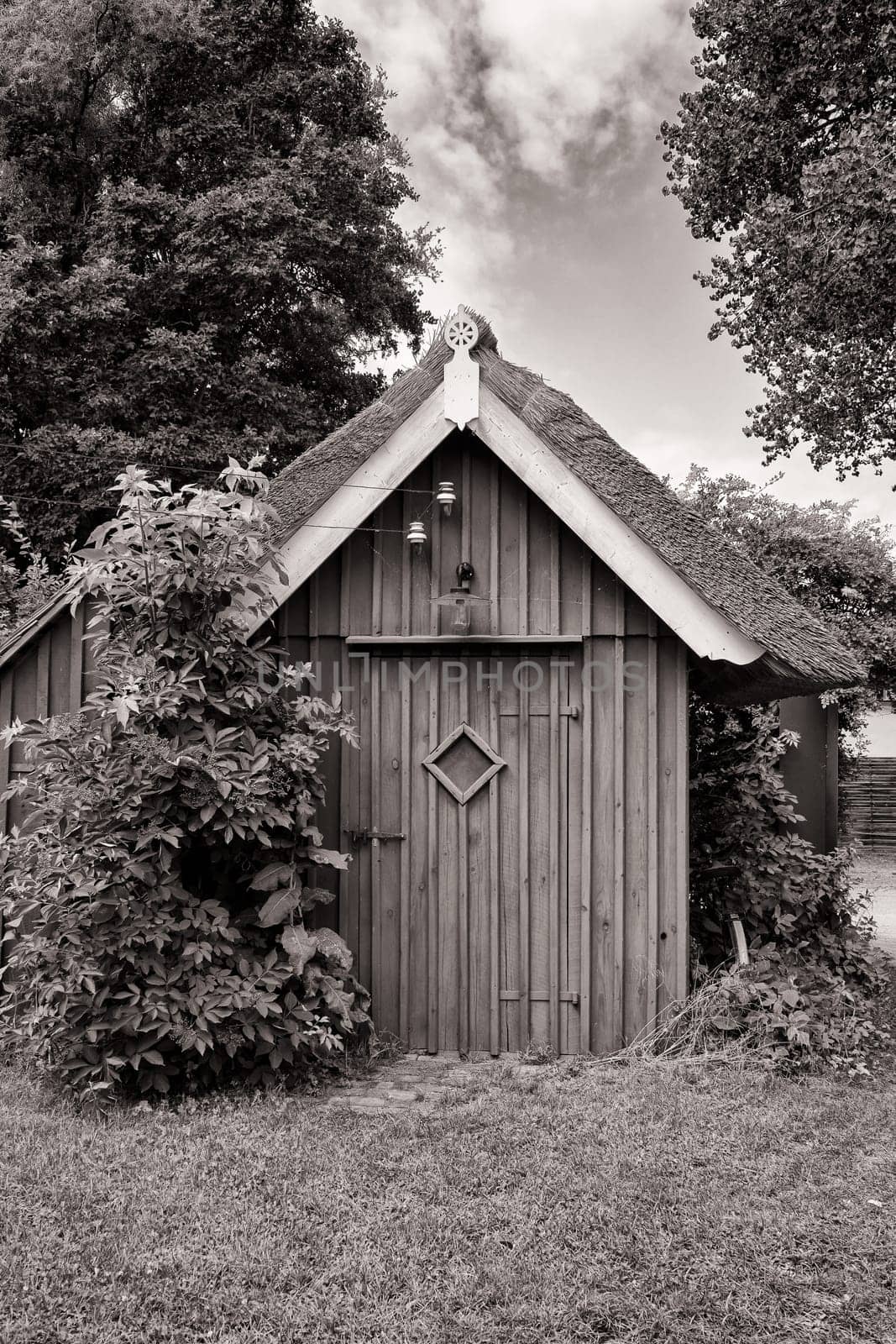 Wooden tool shed with thatched roof