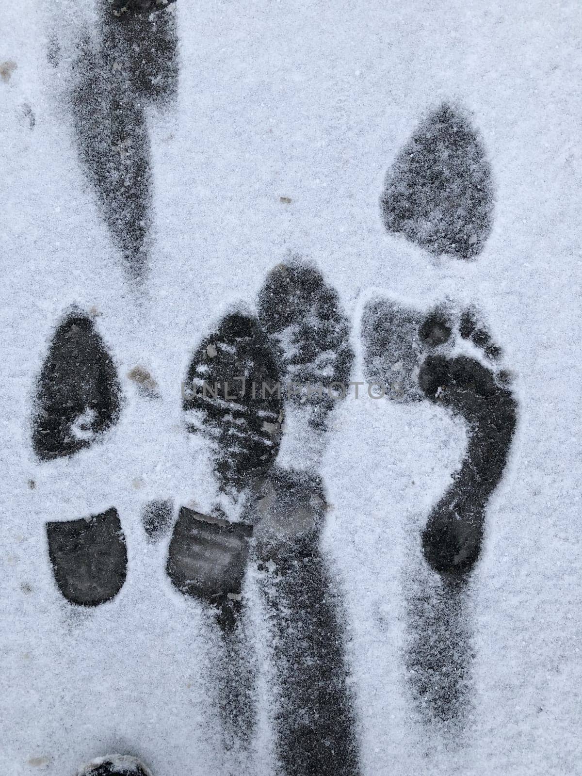footprints of human feet on white snow