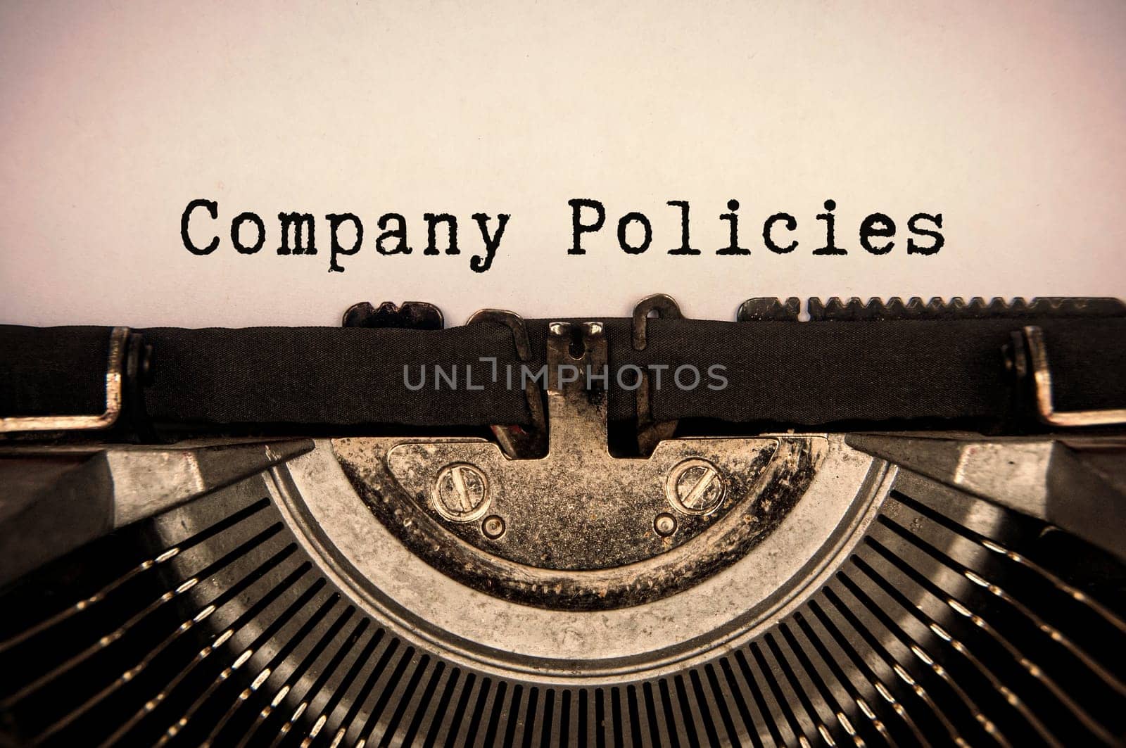 Company policies text typed on an old vintage typewriter.