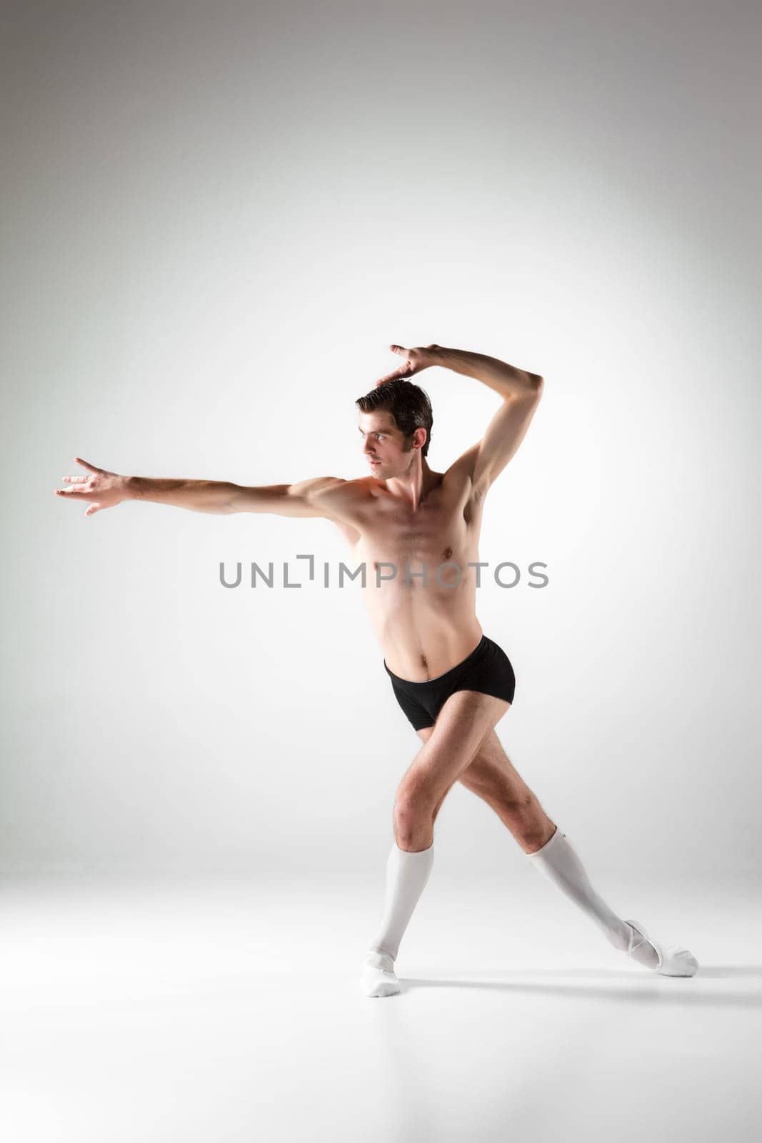 The young attractive modern ballet dancer over white background