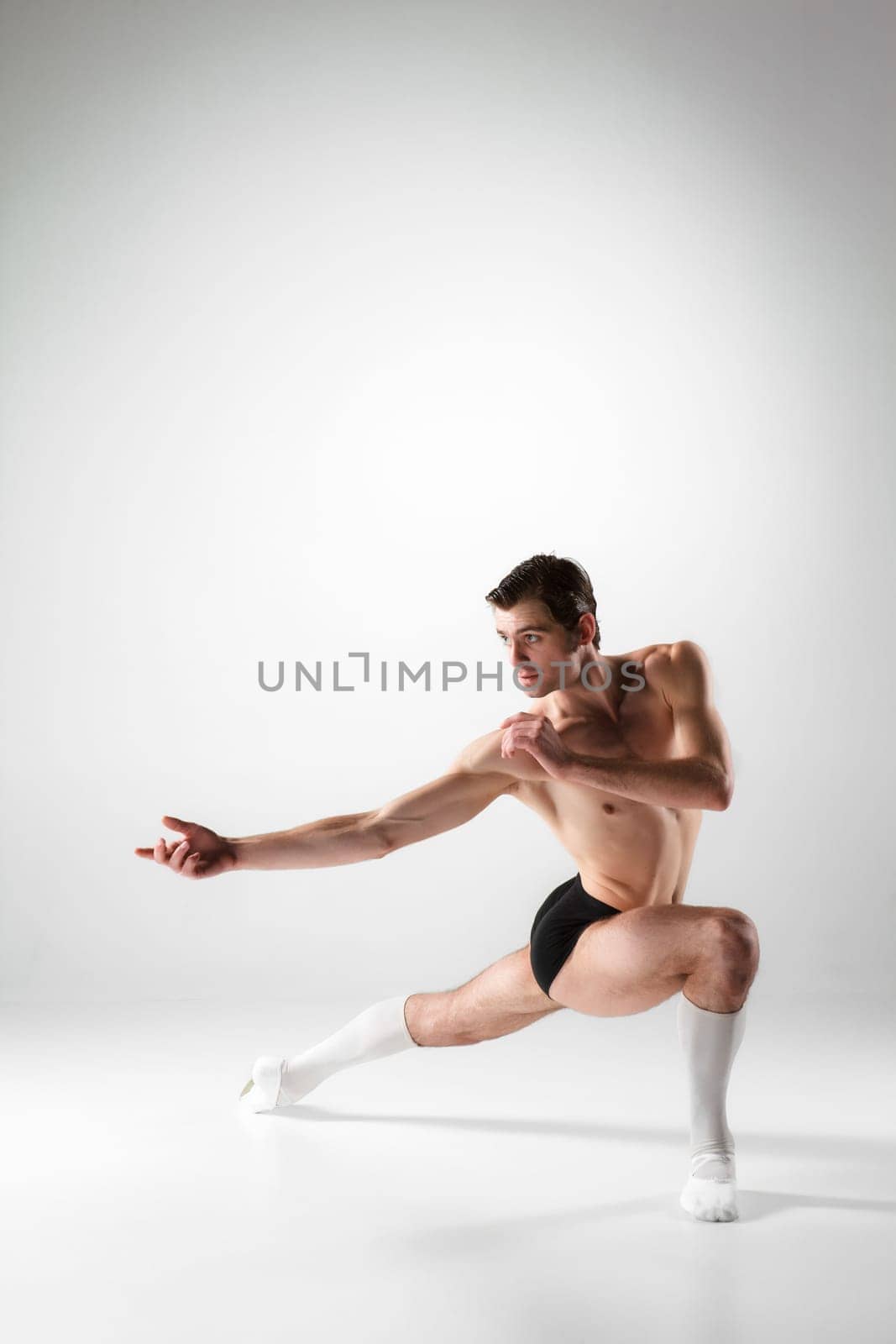 The young attractive modern ballet dancer over white background