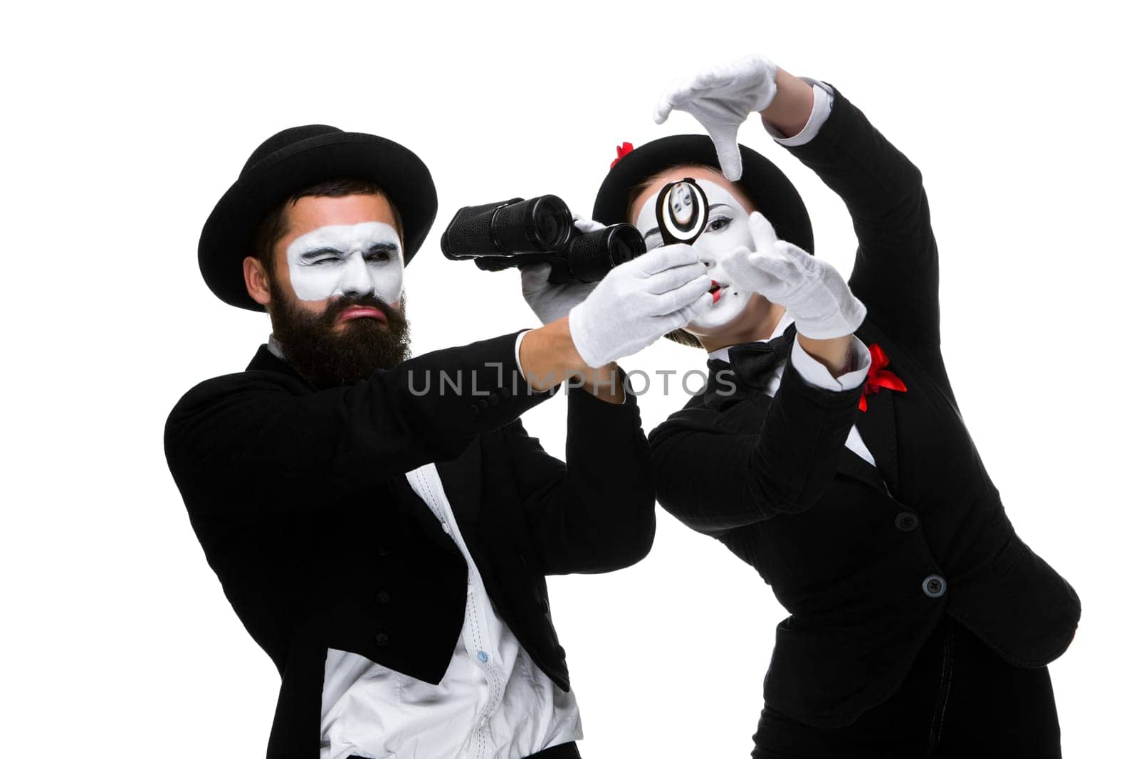 Two memes as business people looking through a magnifying glass and binoculars isolated on white background. concept thorough search