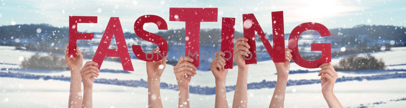 People Hands Holding Red English Word Fasting. Snowy Winter Background With Snowflakes