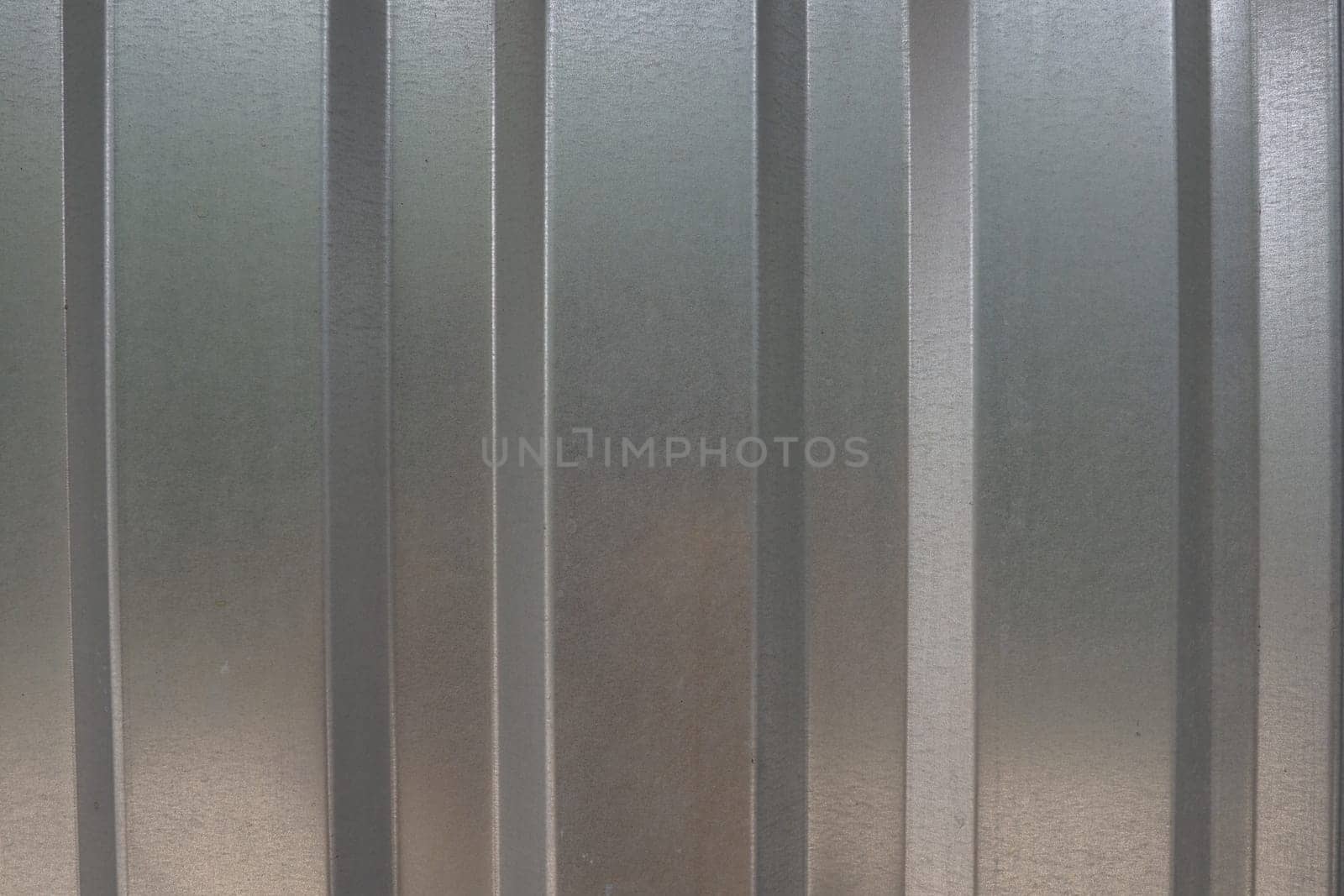 aluminum chrome metal profiled sheet with vertical stripes. metallic gray.