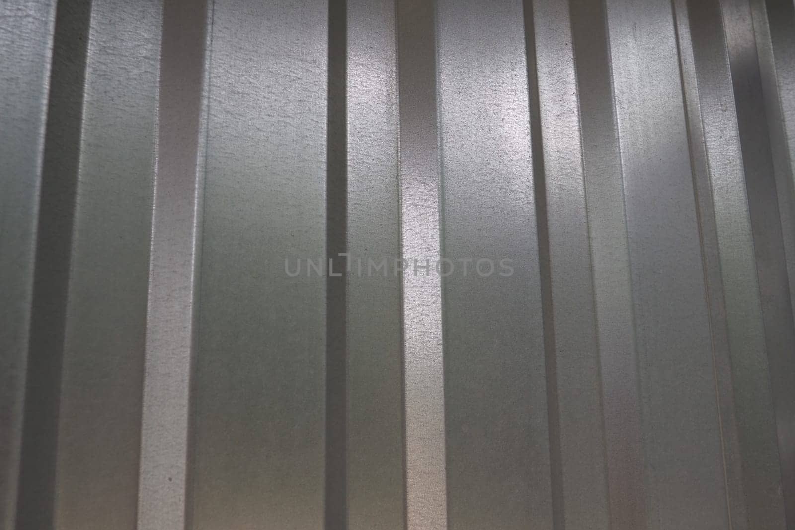 aluminum chrome metal profiled sheet with vertical stripes. metallic gray.
