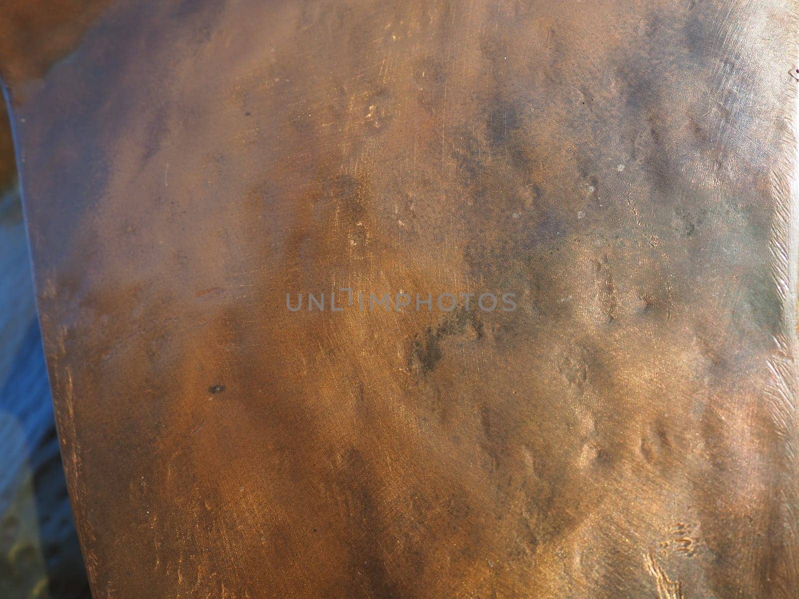 Metal bronze textured plate. Bronze or copper polished surface with dents, scratches and indentations. Metal texture.