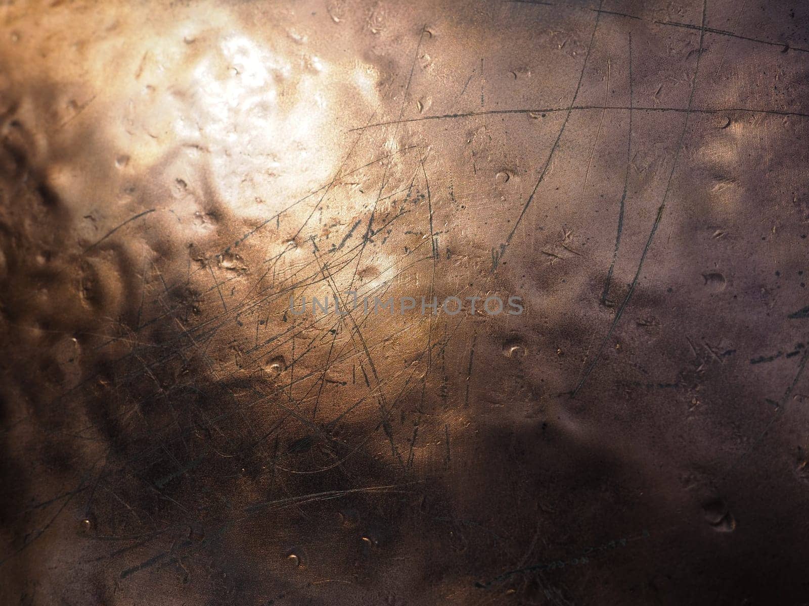 Metal bronze textured plate. Bronze or copper polished surface with dents, scratches and indentations. Metal texture.